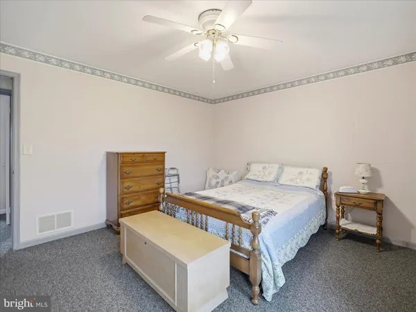 a bed room with a bed and a dresser