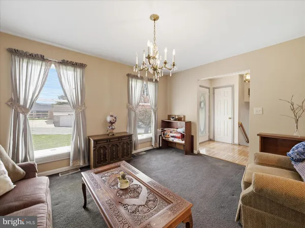 a living room with furniture and a chandelier