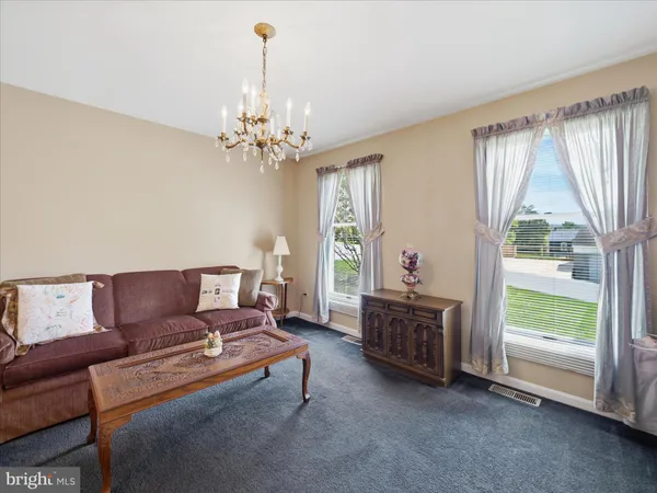 a living room with furniture and a chandelier