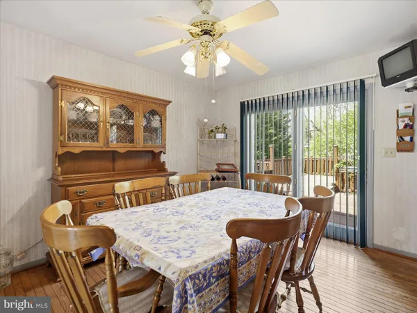 a dining room with furniture a chandelier and window
