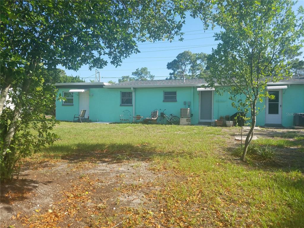 Undisclosed Address Hudson, FL 34667 - Photo 2 of 13 a house view with a garden space