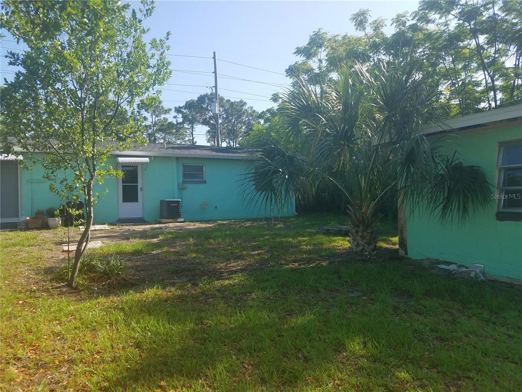 Undisclosed Address Hudson, FL 34667 - Photo 3 of 13 a backyard of a house with plants and large trees