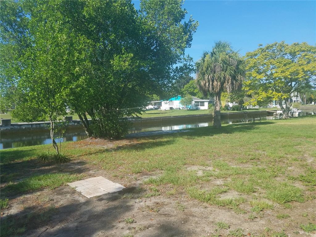 Undisclosed Address Hudson, FL 34667 - Photo 4 of 13 a backyard of a house with lots of green space