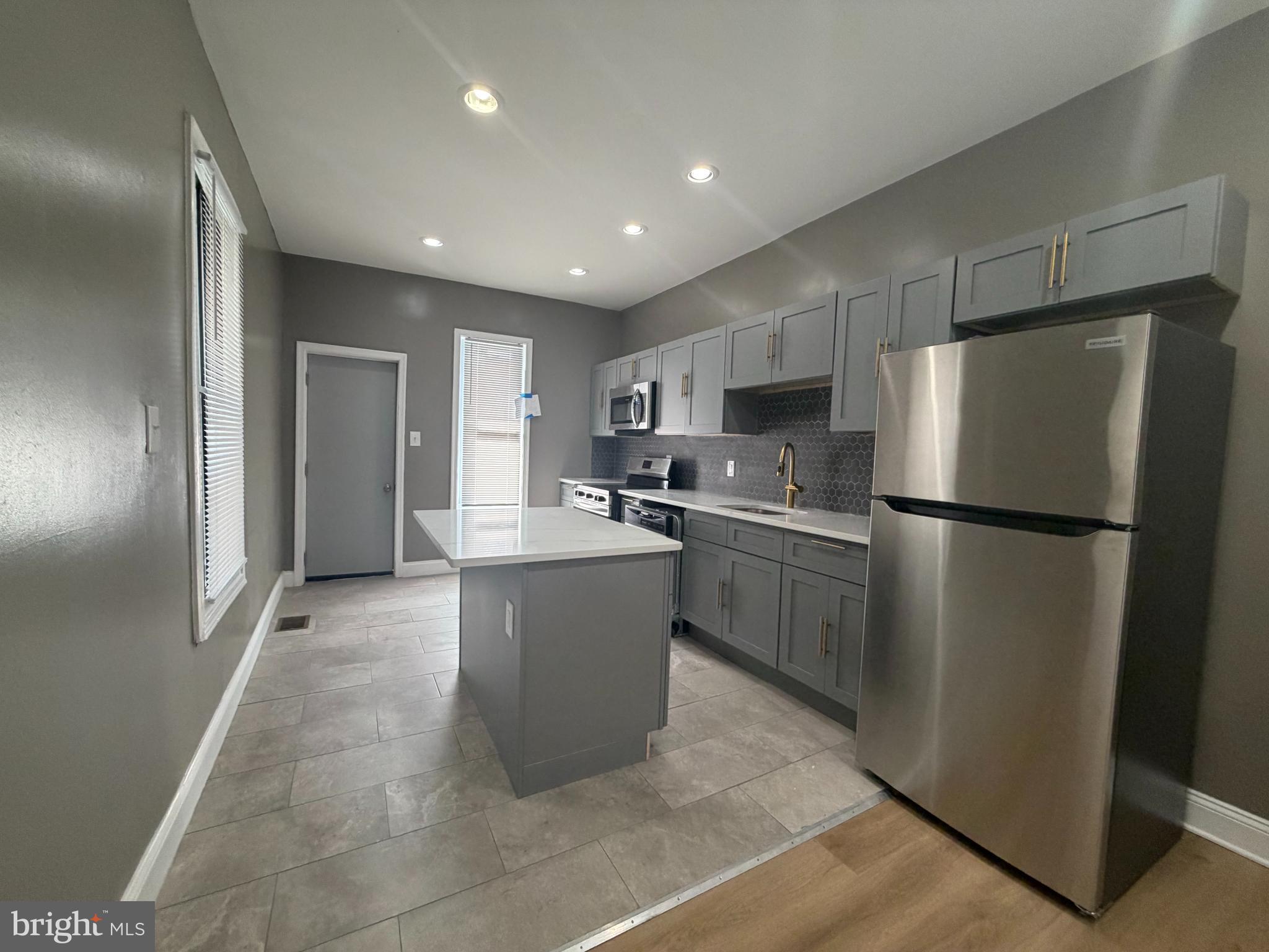2260 North 18th Street Philadelphia, PA 19132 - Photo 6 of 13 a kitchen with granite countertop a refrigerator and a sink