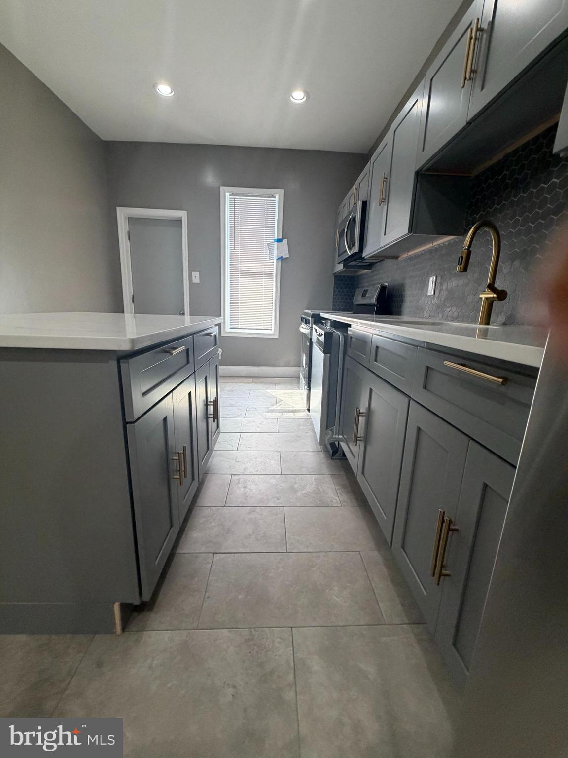2260 North 18th Street Philadelphia, PA 19132 - Photo 8 of 13 a kitchen with granite countertop a sink and cabinets