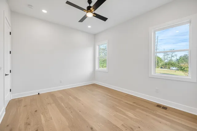 wooden floor in an empty room with a window