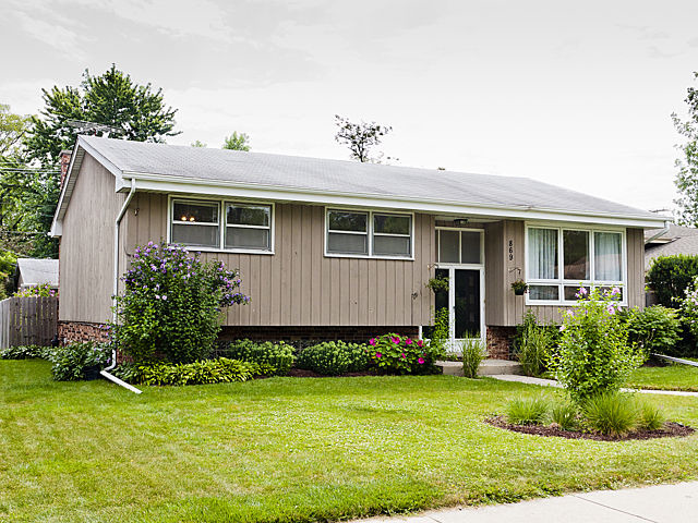 869 Spring Road Elmhurst, IL 60126 - Photo 1 of 25 a front view of a house with garden