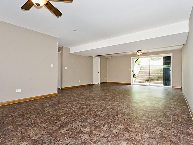 869 Spring Road Elmhurst, IL 60126 - Photo 17 of 25 an empty room with chandelier fan and windows