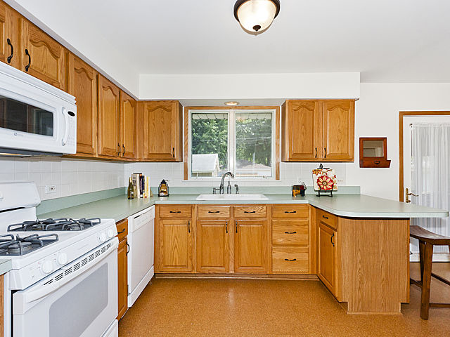 869 Spring Road Elmhurst, IL 60126 - Photo 3 of 25 a kitchen with a sink cabinets and window