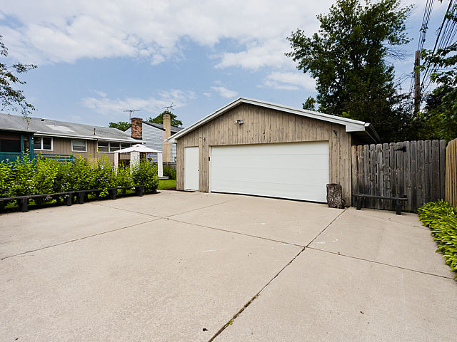 869 Spring Road Elmhurst, IL 60126 - Photo 22 of 25 a front view of a house with a yard and garage