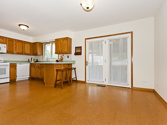 869 Spring Road Elmhurst, IL 60126 - Photo 4 of 25 a view of kitchen with furniture and refrigerator