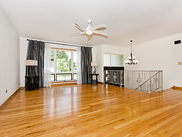 869 Spring Road Elmhurst, IL 60126 - Photo 6 of 25 a view of a livingroom with a flat screen tv and wooden floor