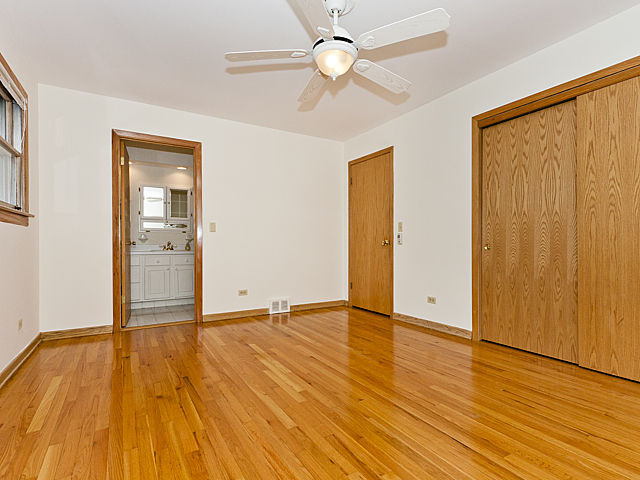 869 Spring Road Elmhurst, IL 60126 - Photo 8 of 25 a view of an empty room with wooden floor