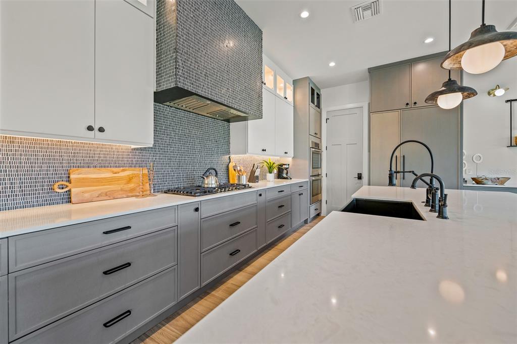 401 77th Street Holmes Beach, FL 34217 - Photo 12 of 92 a kitchen with sink a stove and cabinets