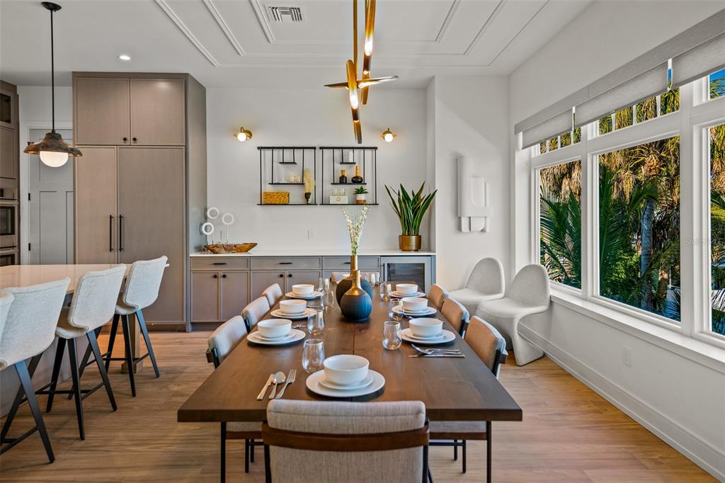 401 77th Street Holmes Beach, FL 34217 - Photo 15 of 92 a view of a dining room with furniture window and wooden floor