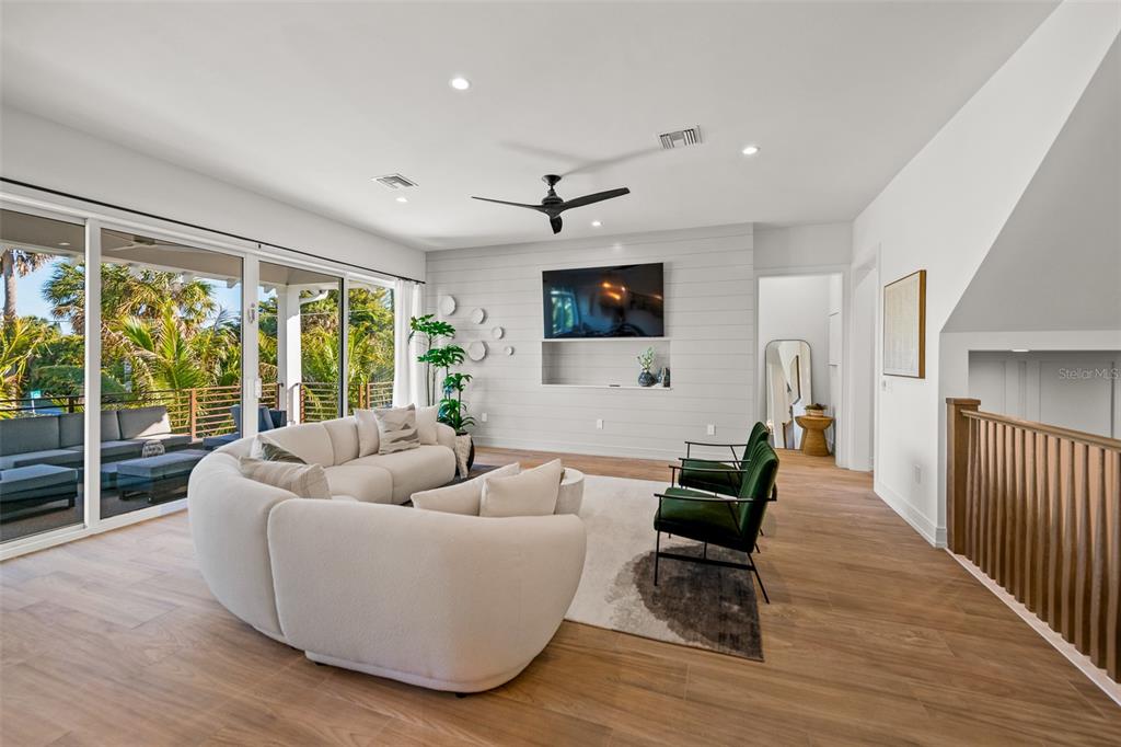 401 77th Street Holmes Beach, FL 34217 - Photo 16 of 92 a living room with furniture and a flat screen tv