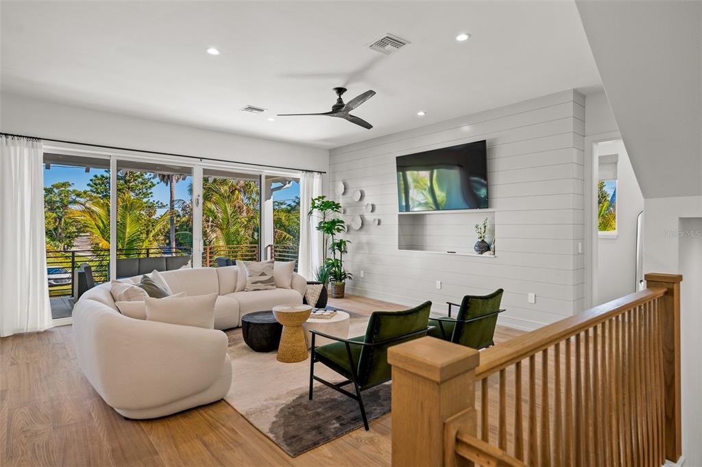 401 77th Street Holmes Beach, FL 34217 - Photo 17 of 92 a living room with furniture and a flat screen tv