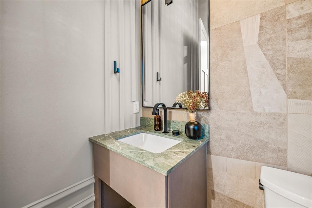 401 77th Street Holmes Beach, FL 34217 - Photo 23 of 92 a bathroom with a sink and a mirror