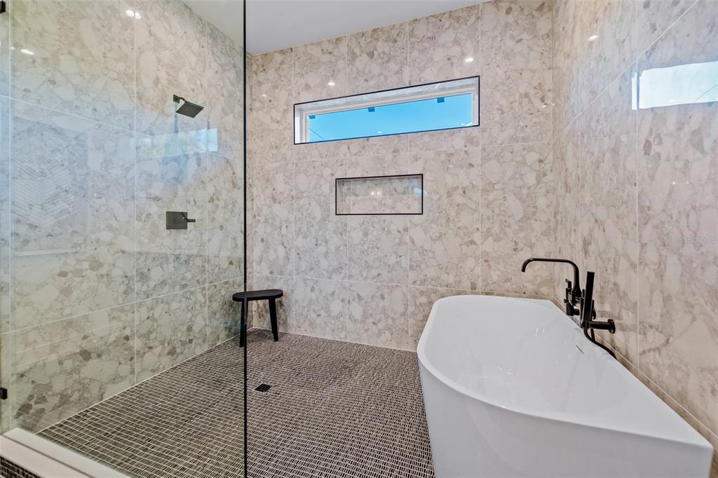 401 77th Street Holmes Beach, FL 34217 - Photo 30 of 92 a bathroom with a bathtub and a shower