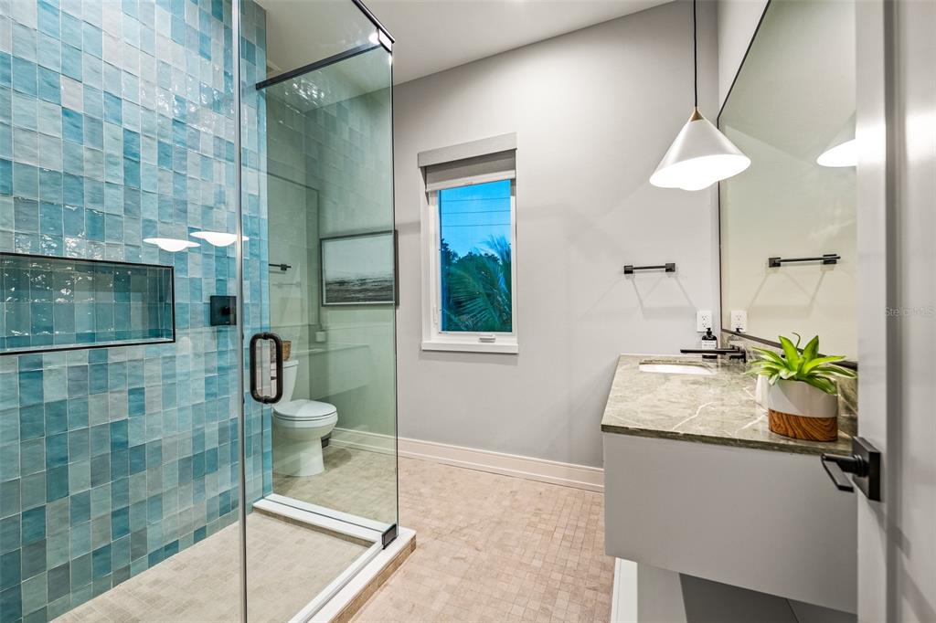 401 77th Street Holmes Beach, FL 34217 - Photo 35 of 92 a bathroom with a sink and a mirror