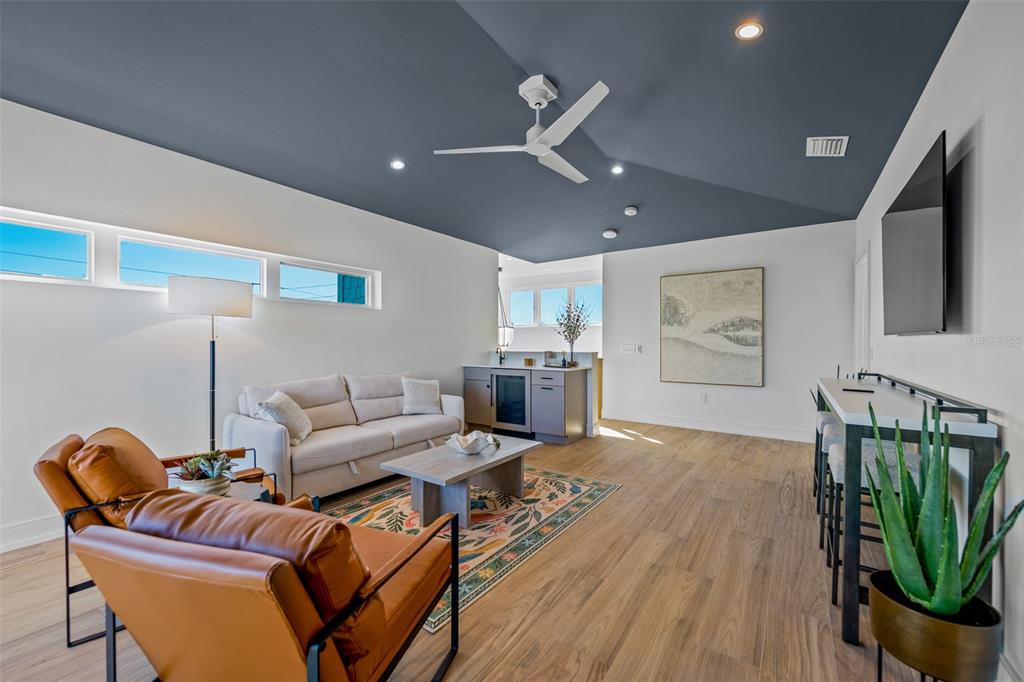 401 77th Street Holmes Beach, FL 34217 - Photo 38 of 92 a living room with furniture a ceiling fan and a rug