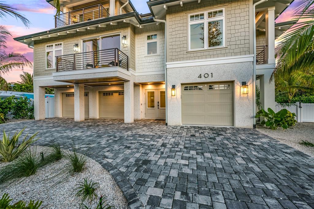 401 77th Street Holmes Beach, FL 34217 - Photo 4 of 92 a front view of a house with a yard and garage