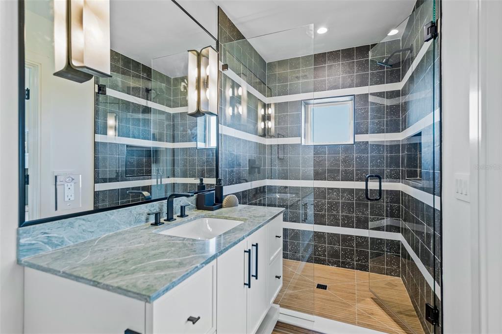 401 77th Street Holmes Beach, FL 34217 - Photo 44 of 92 a bathroom with a sink and a shower
