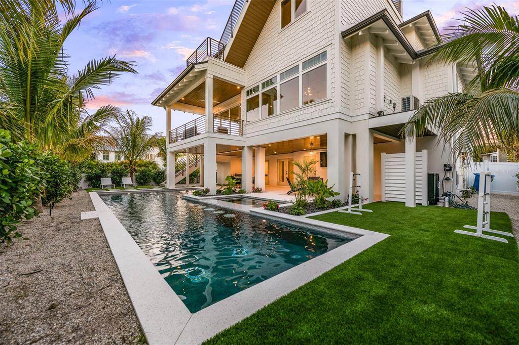 401 77th Street Holmes Beach, FL 34217 - Photo 52 of 92 a view of a house with swimming pool