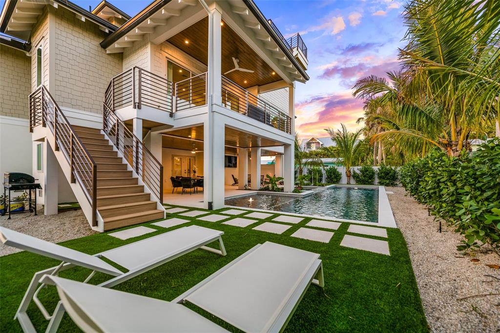 401 77th Street Holmes Beach, FL 34217 - Photo 53 of 92 a view of a house with backyard and sitting area