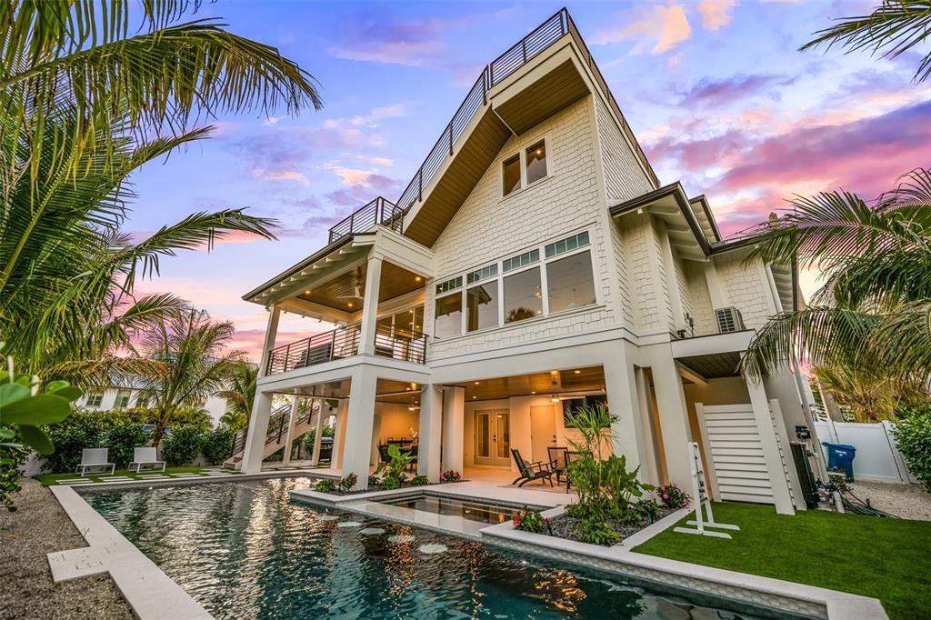 401 77th Street Holmes Beach, FL 34217 - Photo 55 of 92 a front view of a house with a yard