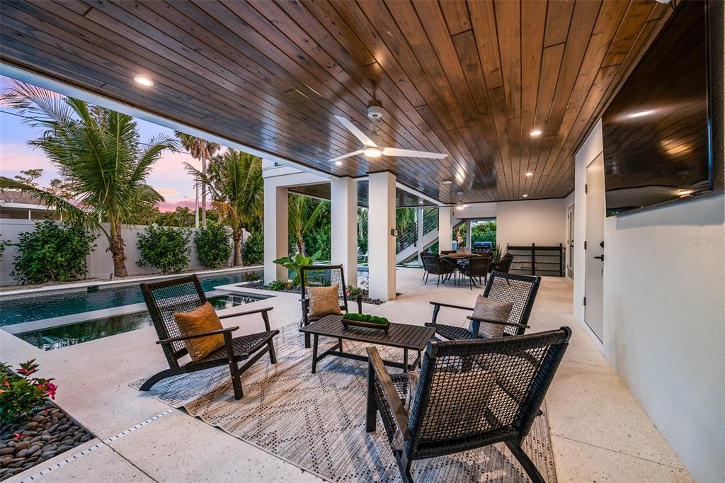 401 77th Street Holmes Beach, FL 34217 - Photo 58 of 92 a outdoor space with lots of tables a garden view and chairs