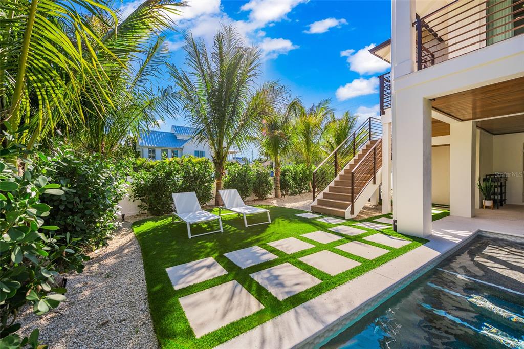 401 77th Street Holmes Beach, FL 34217 - Photo 68 of 92 a view of a backyard with sitting area