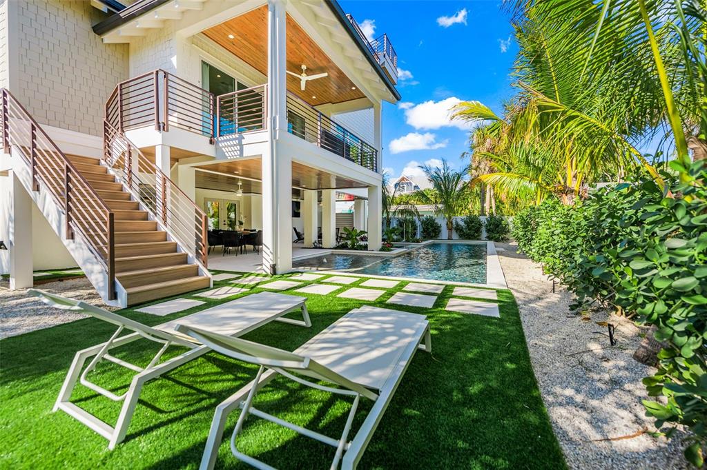 401 77th Street Holmes Beach, FL 34217 - Photo 69 of 92 a view of a house with pool and sitting area