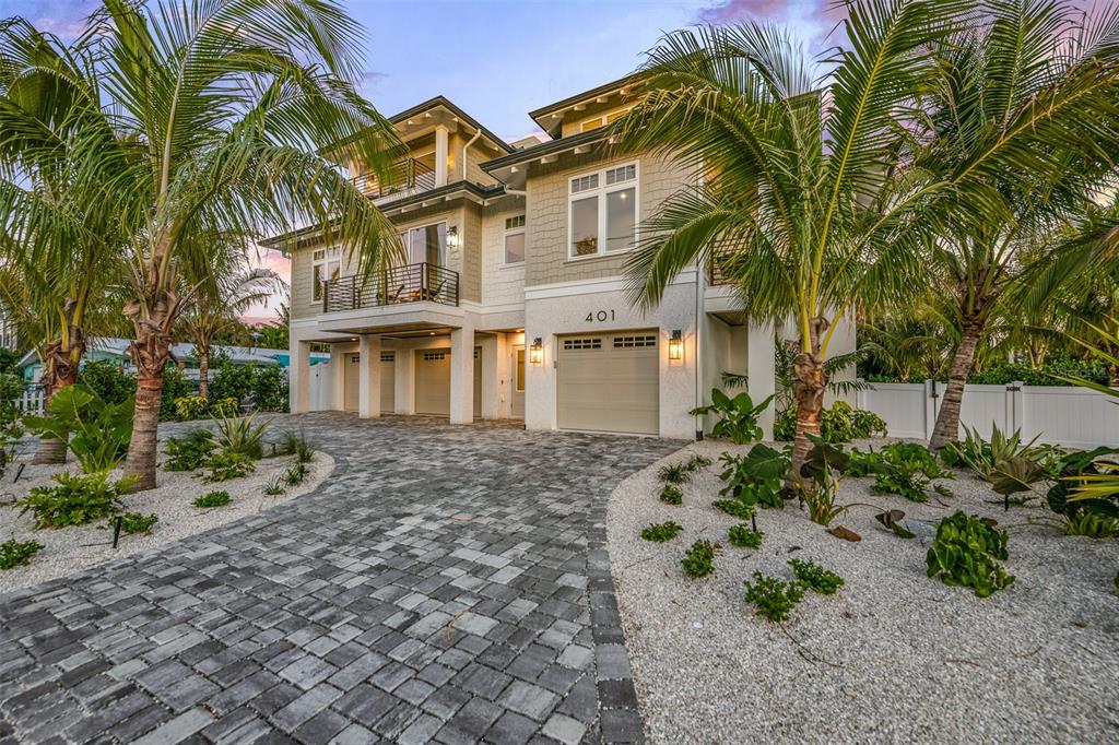 401 77th Street Holmes Beach, FL 34217 - Photo 74 of 92 a front view of a house with garden
