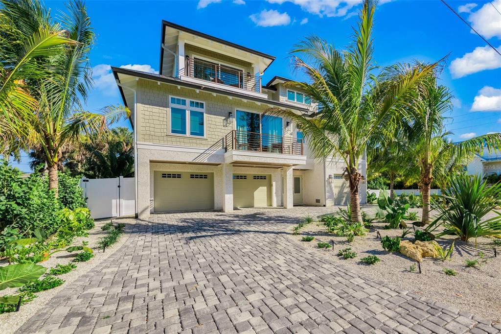 401 77th Street Holmes Beach, FL 34217 - Photo 75 of 92 a front view of a house with a yard