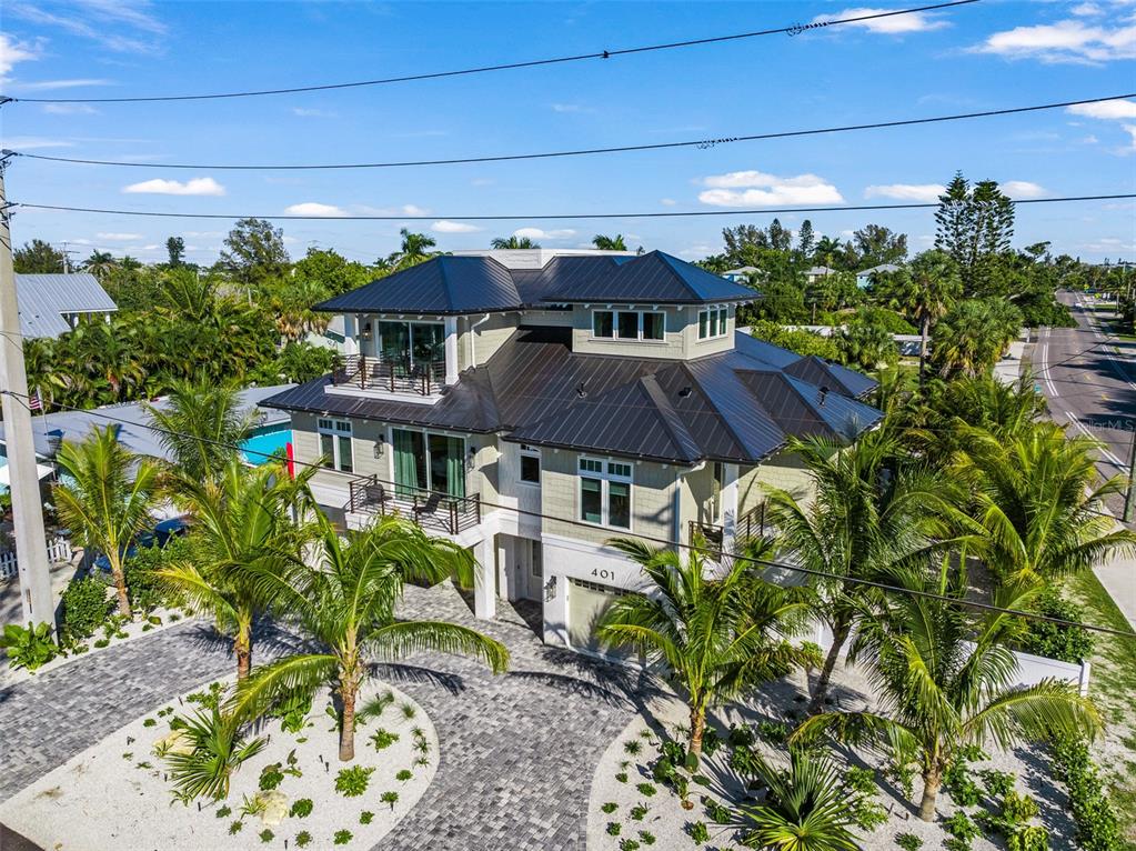 401 77th Street Holmes Beach, FL 34217 - Photo 81 of 92 a view of a patio with table and chairs under an umbrella