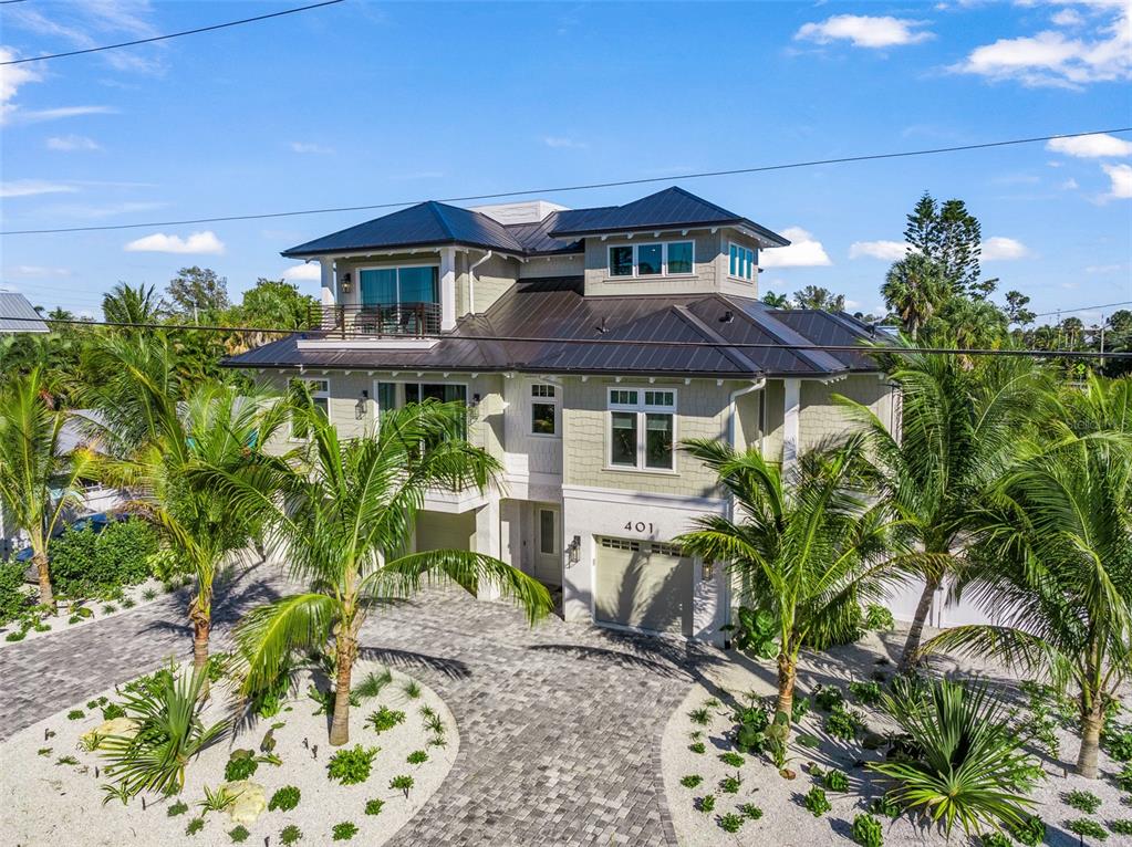 401 77th Street Holmes Beach, FL 34217 - Photo 83 of 92 a front view of a house with garden