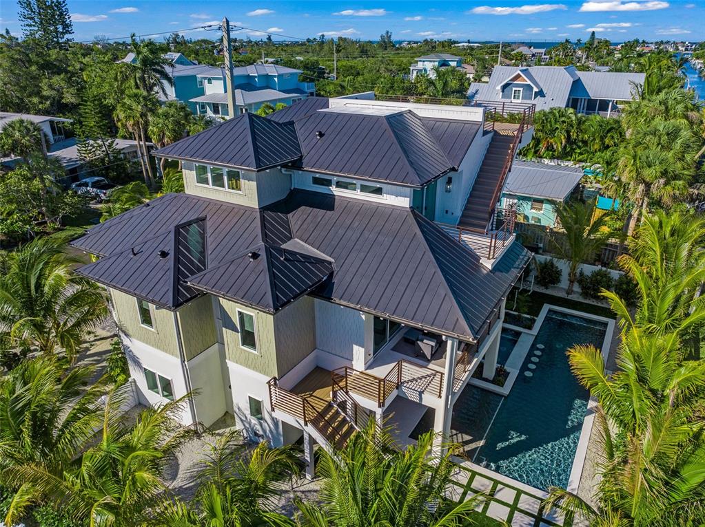 401 77th Street Holmes Beach, FL 34217 - Photo 91 of 92 an aerial view of a house with garden space and street view