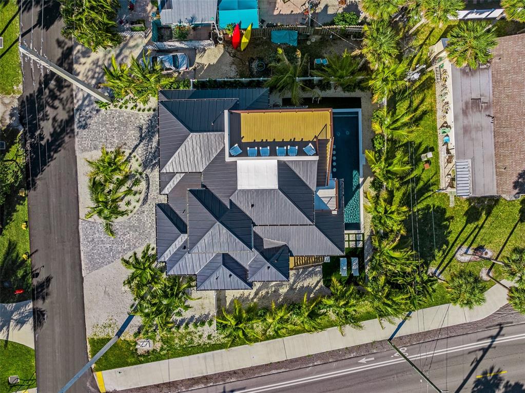 401 77th Street Holmes Beach, FL 34217 - Photo 92 of 92 an aerial view of a house yard and swimming pool