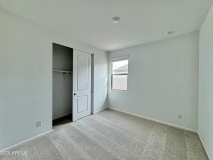 a view of a swimming pool with a chairs and table in the patio