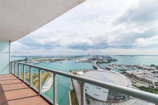 a view of a city from a balcony with outdoor seating