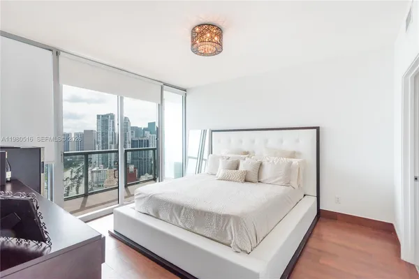 a bedroom with a large bed and a large window