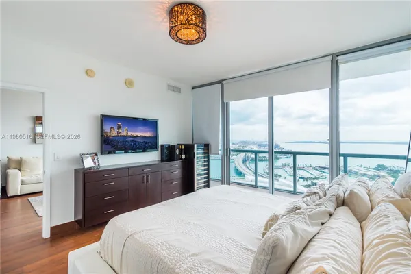 a bedroom with a bed and a flat screen tv