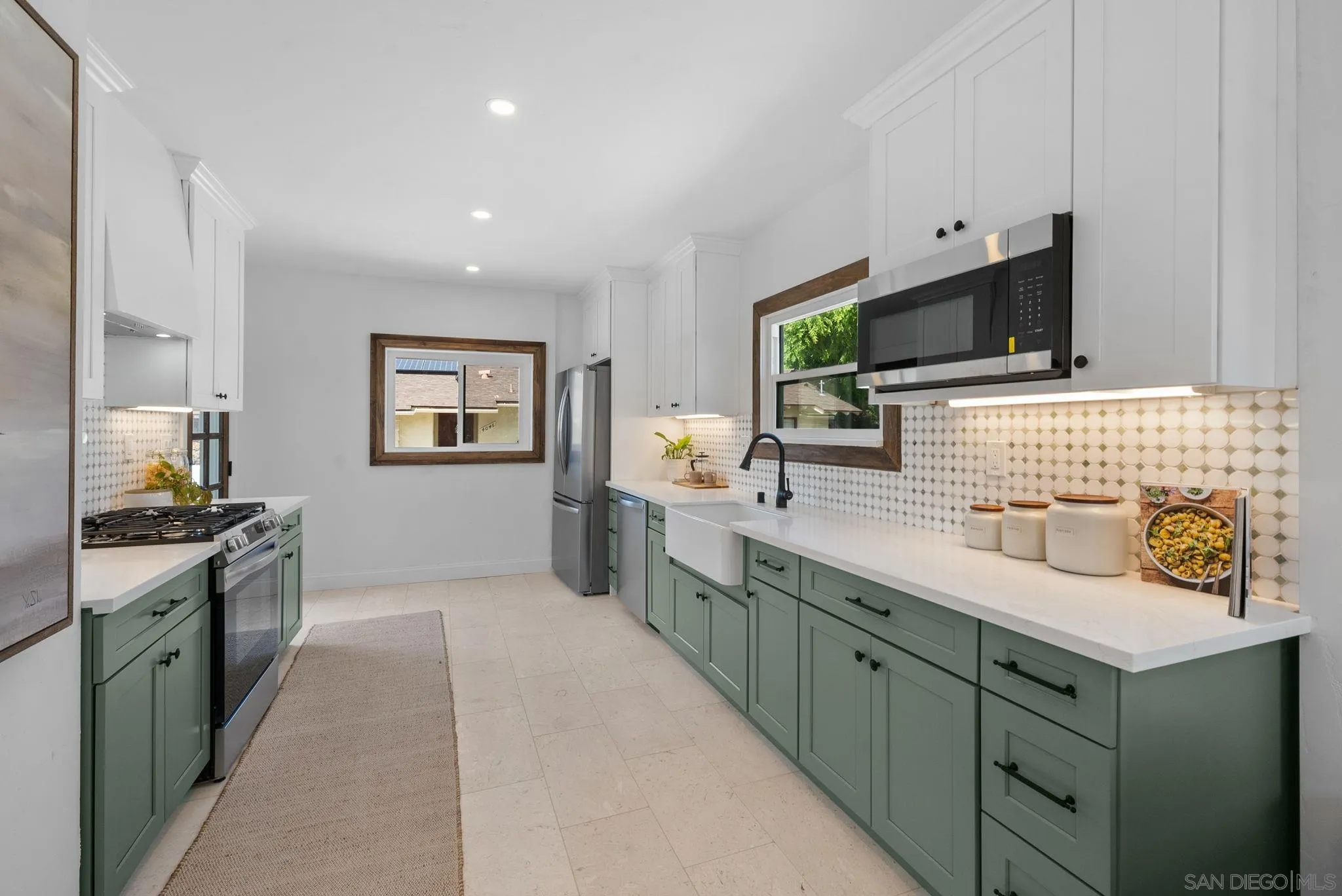 4052 Alder Drive San Diego, CA 92116 - Photo 11 of 28 a kitchen with stainless steel appliances granite countertop a sink and a stove