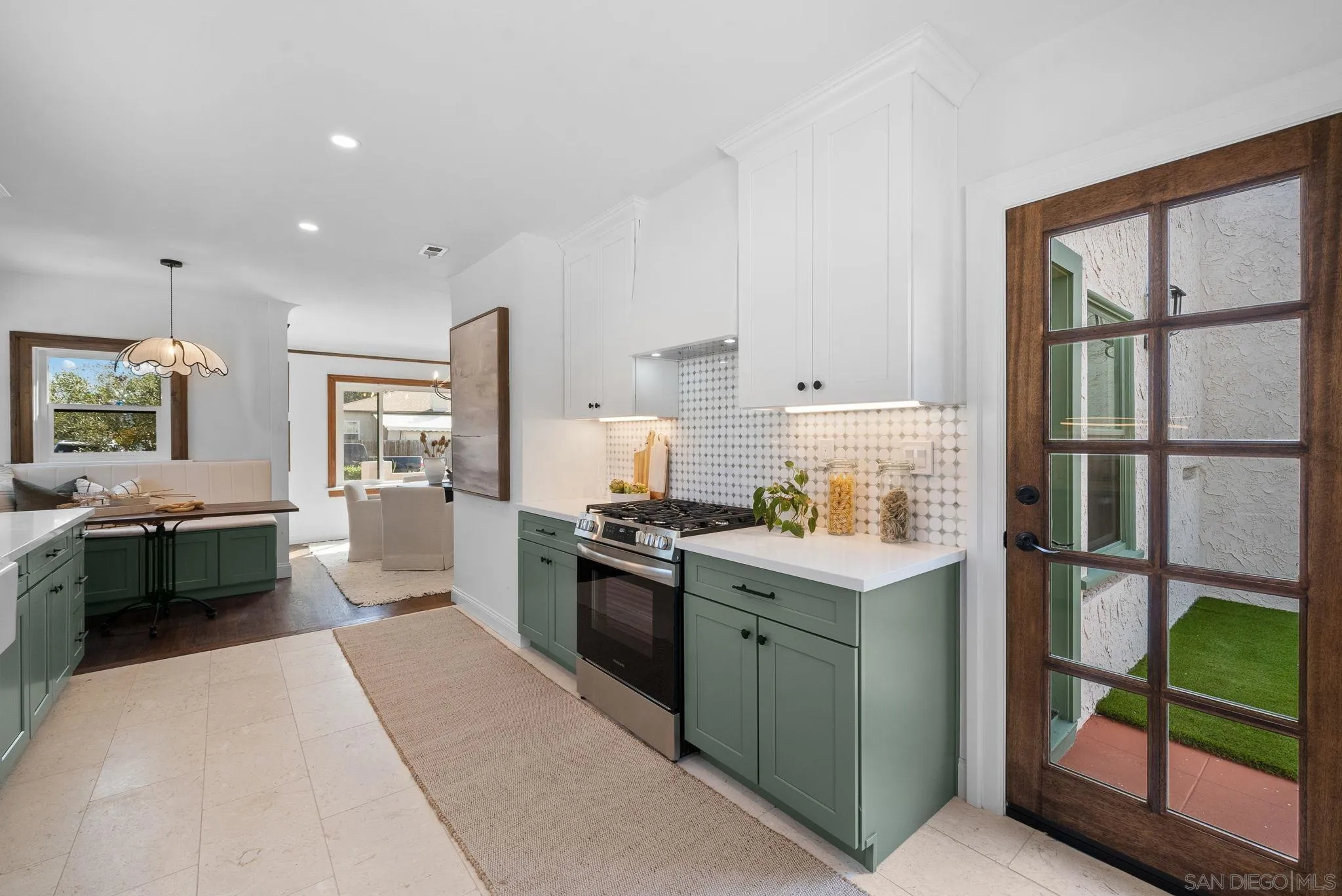 4052 Alder Drive San Diego, CA 92116 - Photo 12 of 28 a kitchen with stainless steel appliances granite countertop a stove top oven and sink