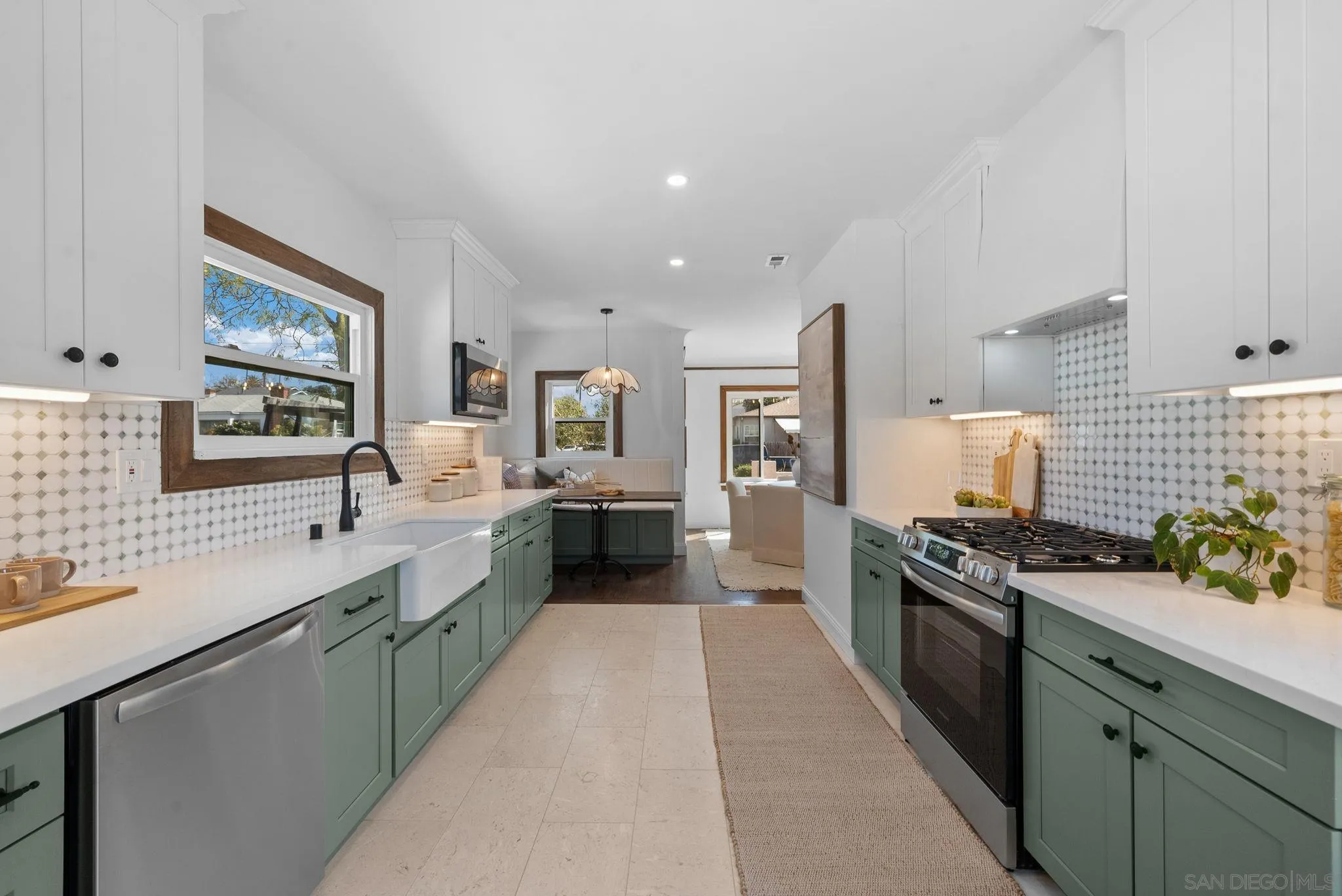 4052 Alder Drive San Diego, CA 92116 - Photo 13 of 28 a large kitchen with stainless steel appliances a sink stove and cabinets