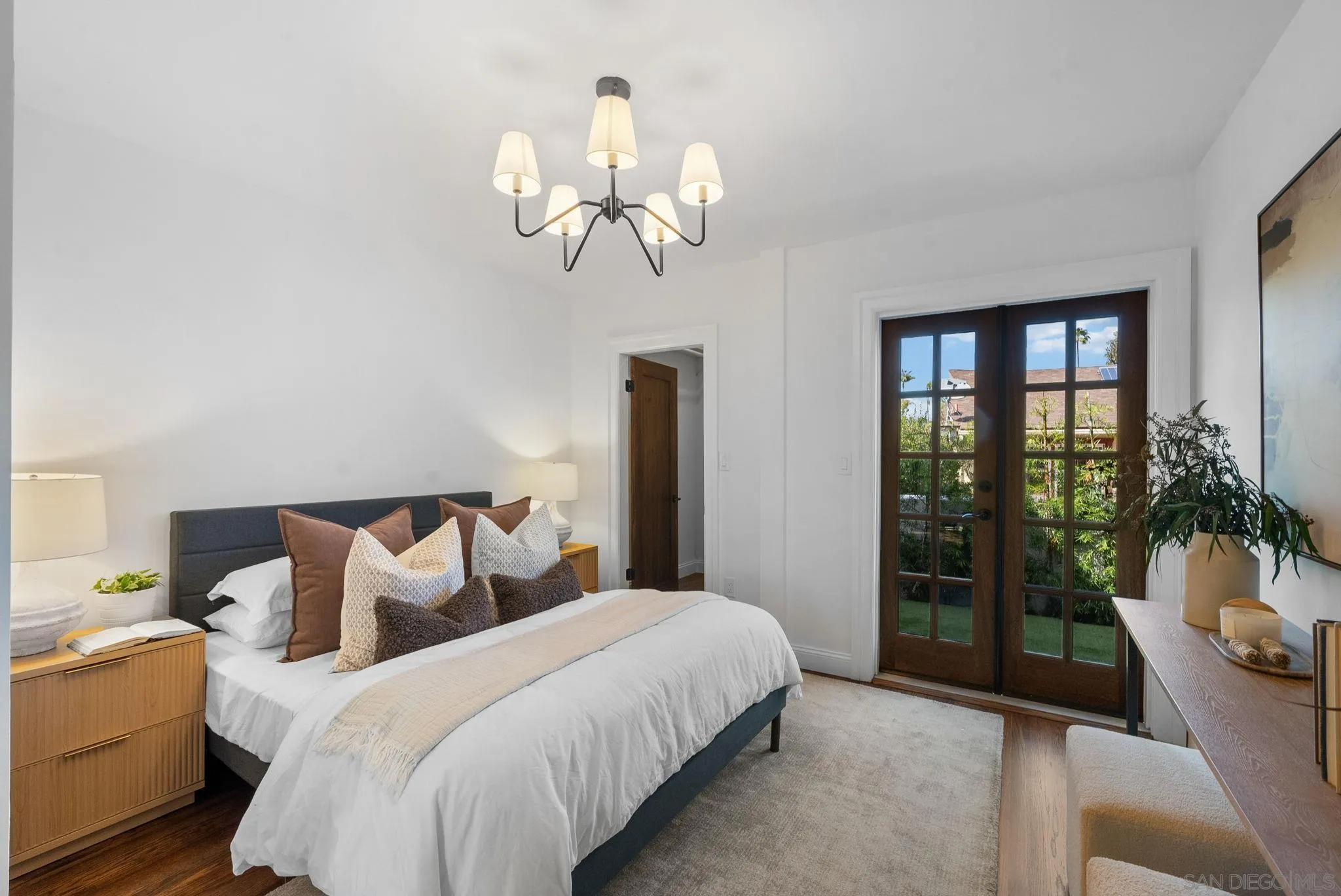 4052 Alder Drive San Diego, CA 92116 - Photo 16 of 28 a bedroom with bed and a chandelier