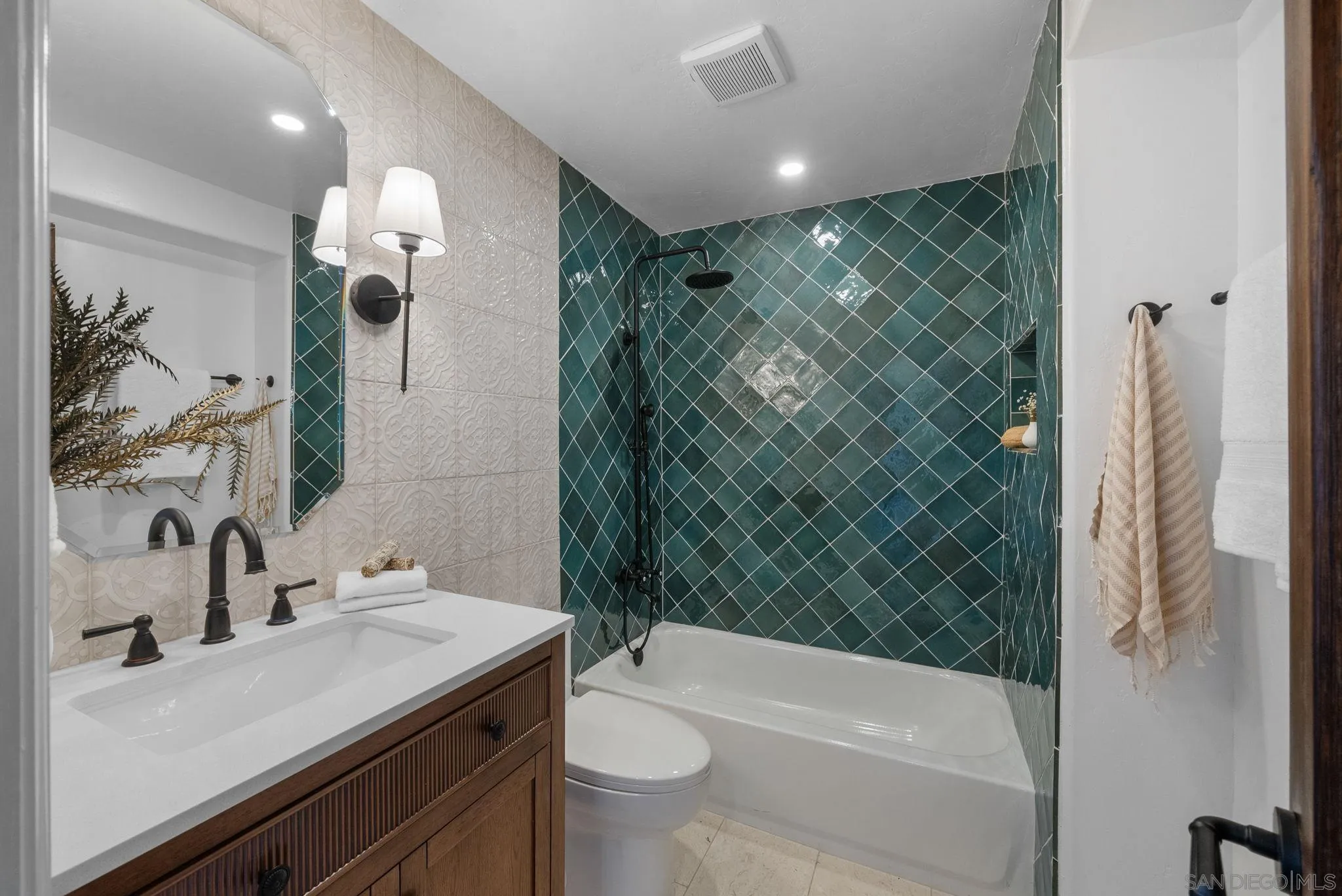 4052 Alder Drive San Diego, CA 92116 - Photo 20 of 28 a bathroom with a sink a toilet and shower