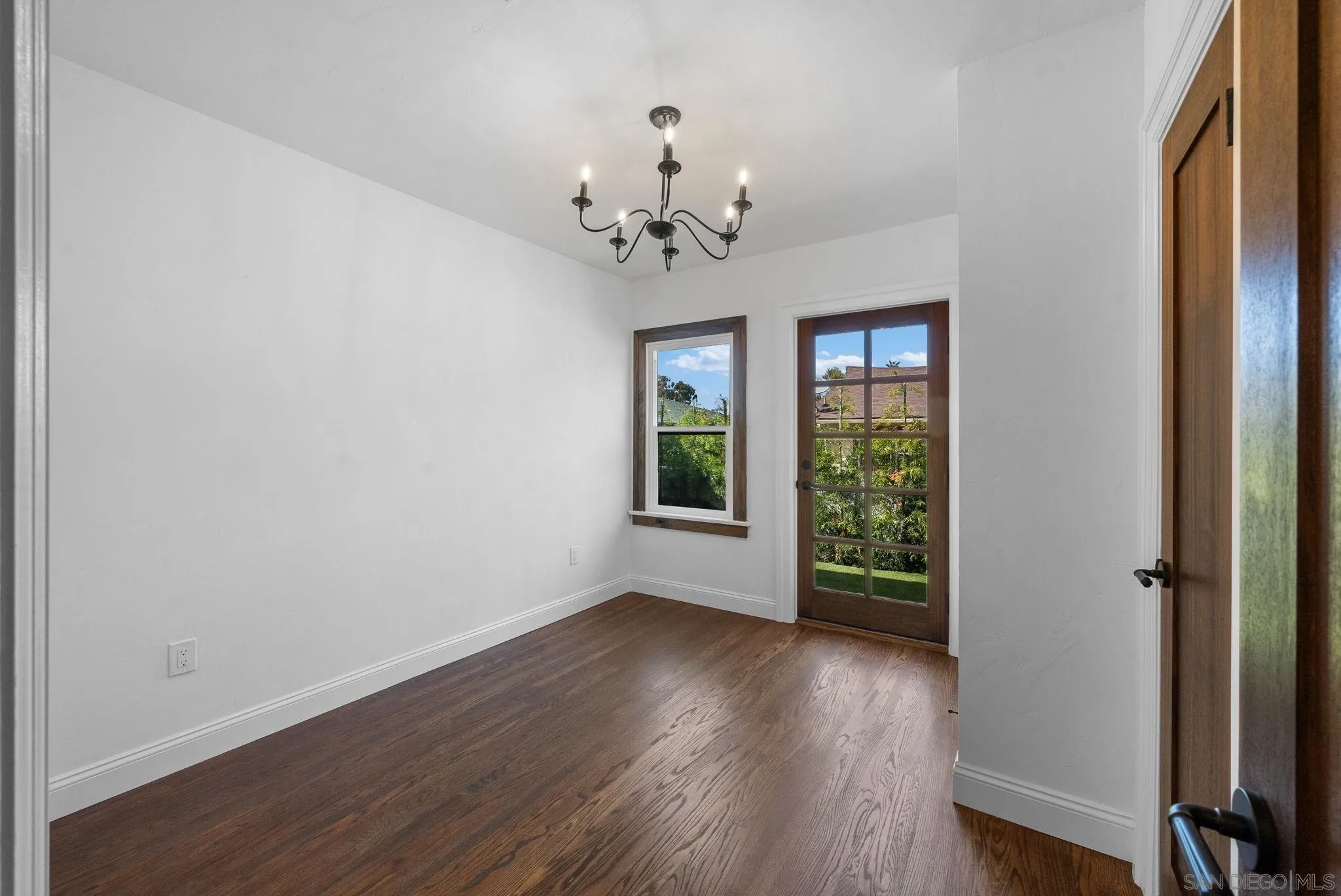 4052 Alder Drive San Diego, CA 92116 - Photo 21 of 28 a view of an empty room with wooden floor and a window