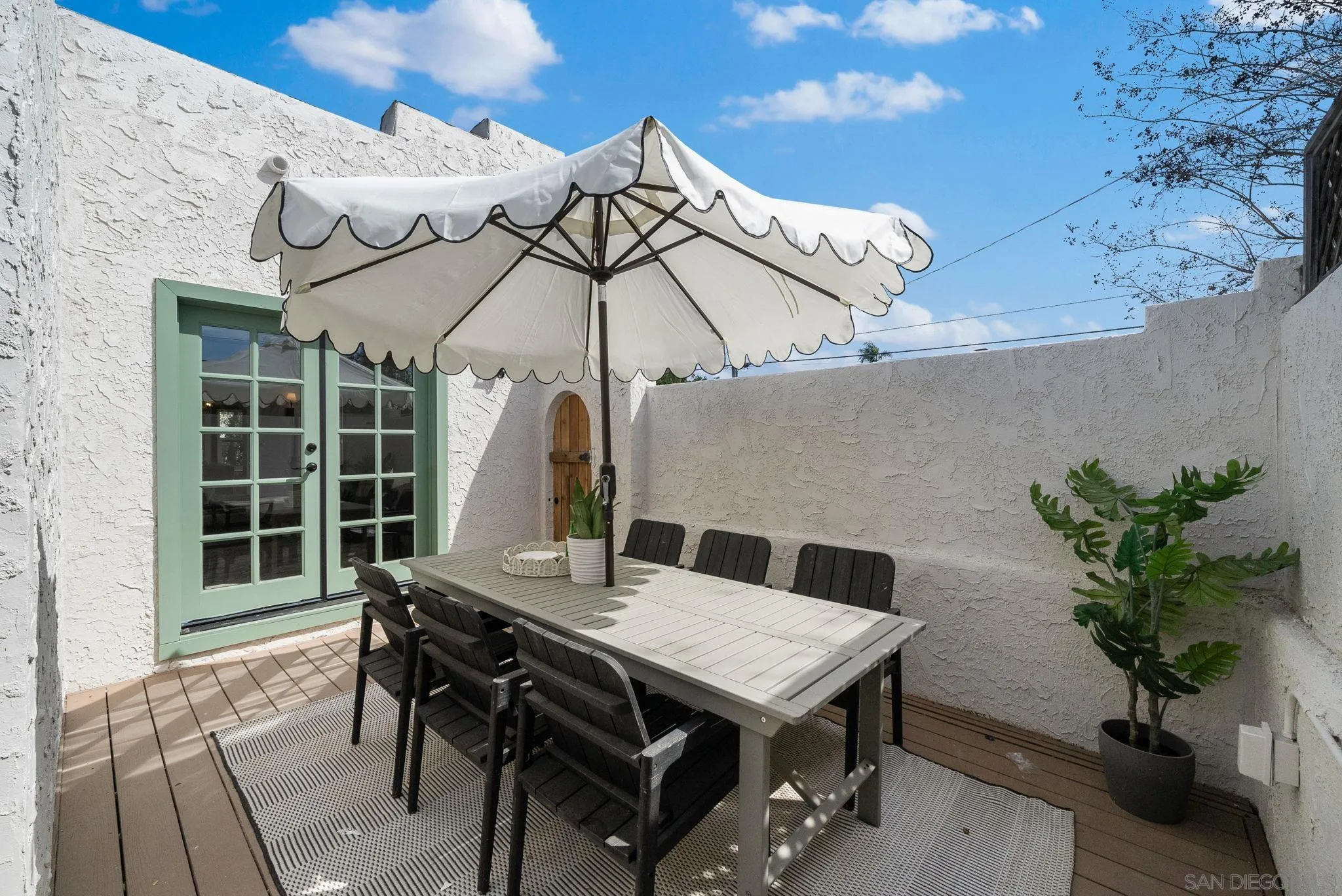 4052 Alder Drive San Diego, CA 92116 - Photo 24 of 28 a roof deck with a table and chairs